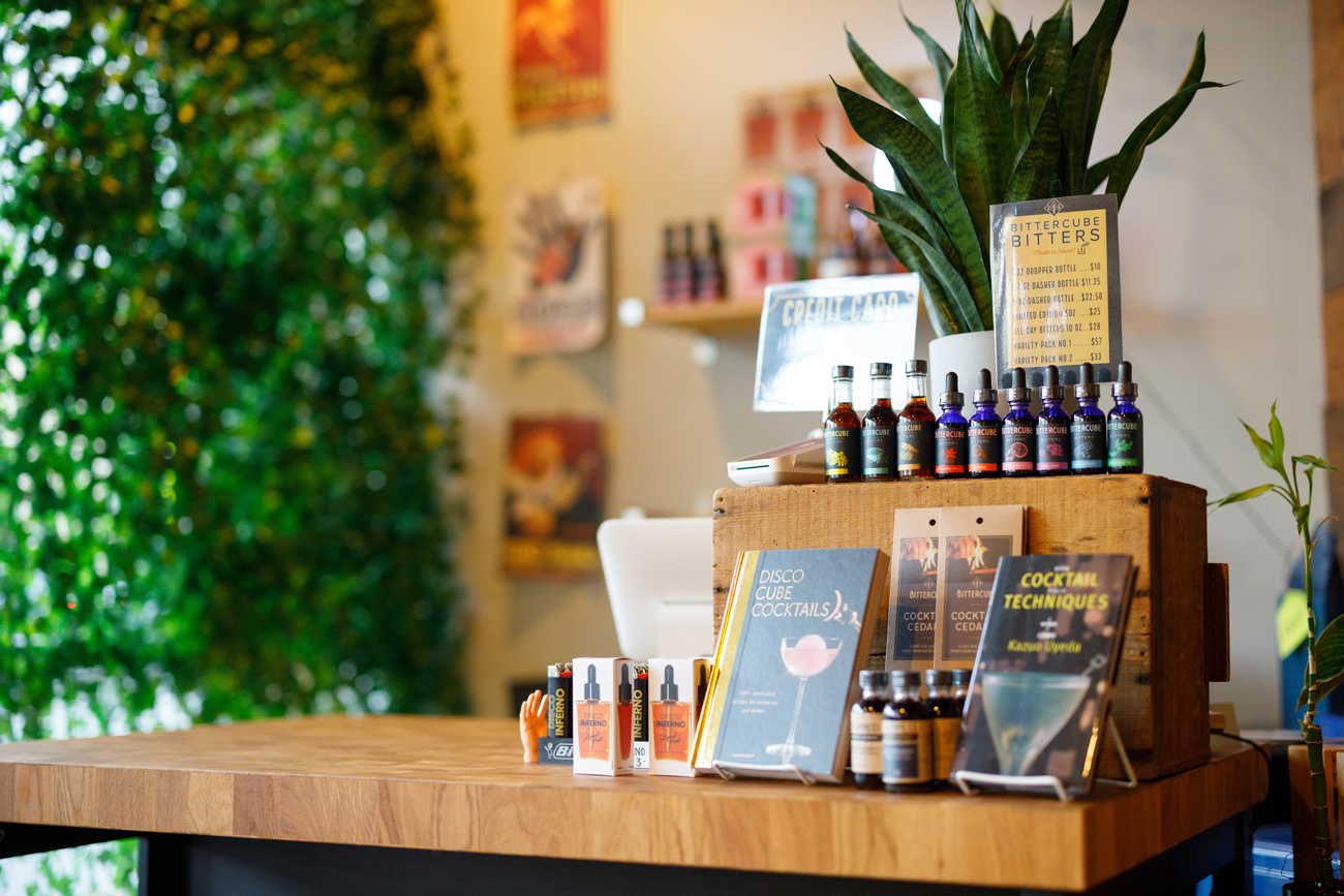 A shop display with bitters and cocktail books